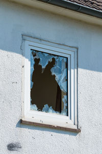 Low angle view of window on wall of building