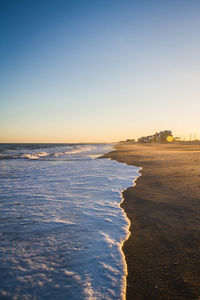 Scenic view of sea against clear sky during sunset