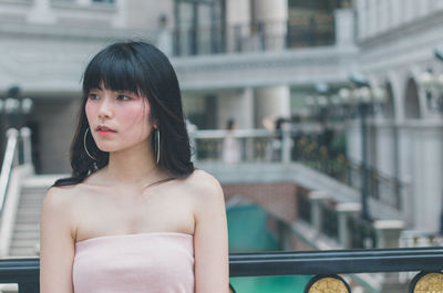 Thoughtful young woman in balcony 