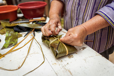 Midsection of man working on table