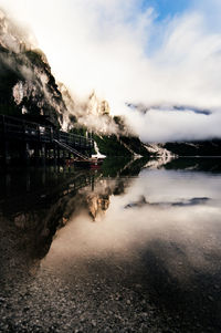 Scenic view of lake by city against sky