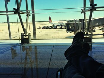 Low section of man sitting on airplane window