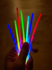 Close-up of hand holding multi colored light