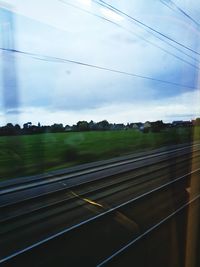 View of railway tracks against cloudy sky