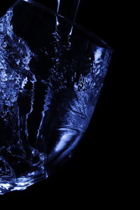 Close-up of water splashing against black background