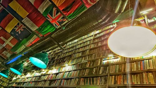 Low angle view of illuminated pendant light hanging from ceiling