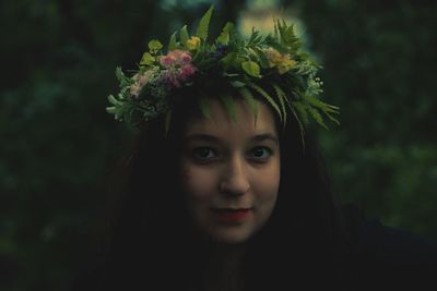 Close-up portrait of young woman with flowers