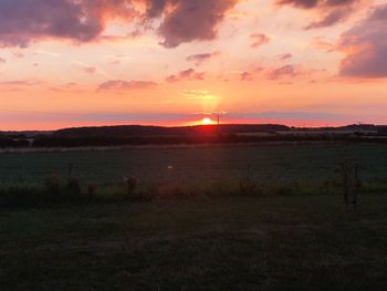 Scenic view of field against sky during sunset