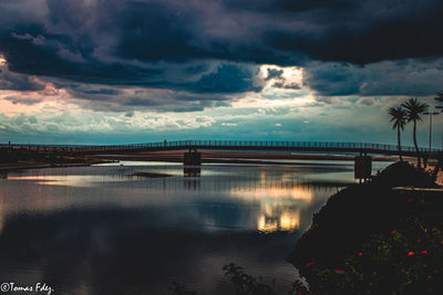 Bridge over river against sky during sunset