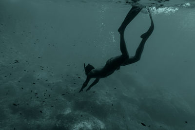 Full length of shirtless man swimming in sea