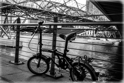 Bicycle on bridge against sky