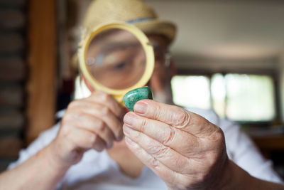 Close-up of man holding gemstone