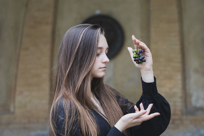 Portrait of young woman holding mobile phone