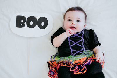 Portrait of cute baby lying on bead at home