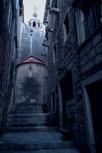 Low angle view of staircase amidst buildings in city