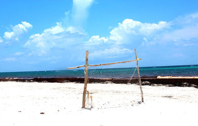 Scenic view of beach against cloudy sky