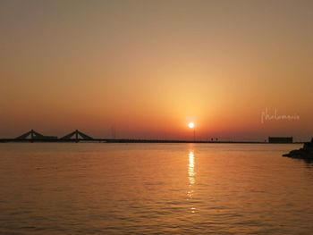 Scenic view of sea against orange sky