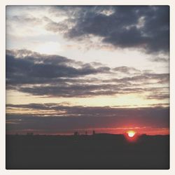 Scenic view of dramatic sky at sunset