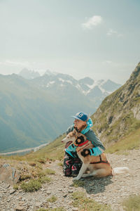 Boy on mountain against sky