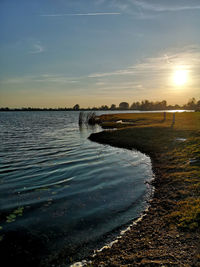 Scenic view of river against sky during sunset