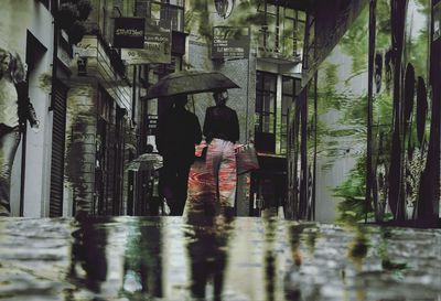 Rear view of people standing in water