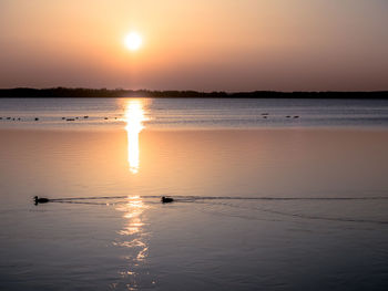 Scenic view of lake against sky during sunset