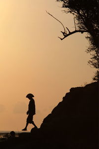 Silhouette of woman at sunset