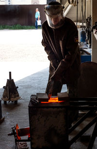 Man working on barbecue grill