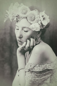 Woman with flowers on her head recalling the style of frida viii