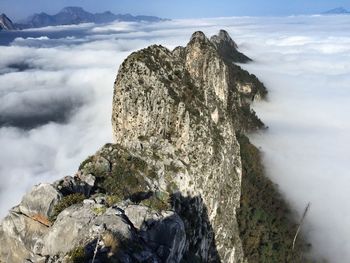 Scenic view of rocky mountains against cloudy sky