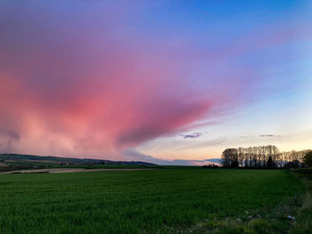 Scenic view of field against sky during sunset