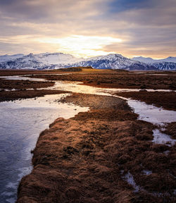 Scenic view of snowcapped mountains against sky during sunset