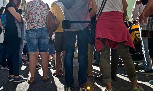 Low section of people standing on street