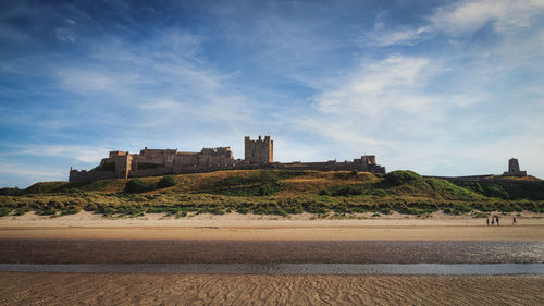 Buildings against cloudy sky
