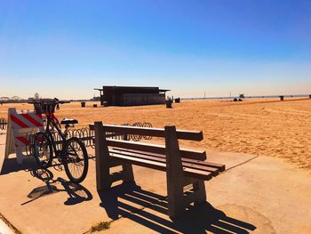 Lifeguard hut on beach against clear blue sky