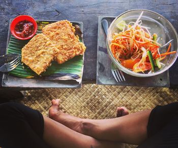 High angle view of hand holding food on table