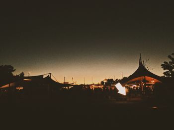 Silhouette buildings against sky at dusk