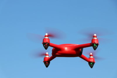 Red drone on a blue sky background