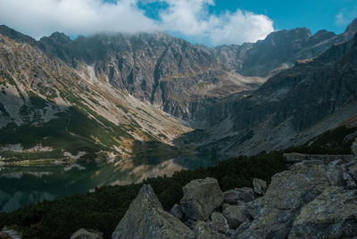 Scenic view of mountains against cloudy sky