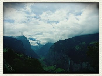 Scenic view of mountains against cloudy sky
