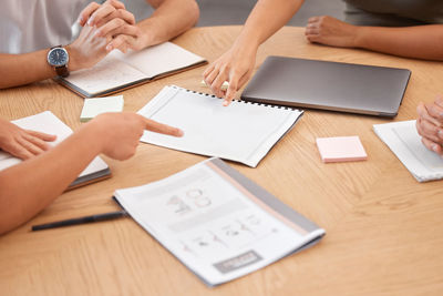 Midsection of businessman working on table