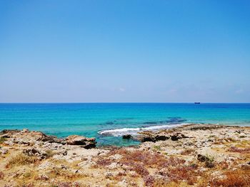 Scenic view of sea against clear blue sky