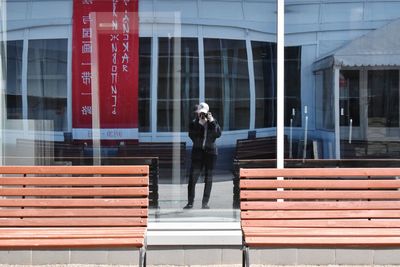 Full length of man standing by building in city