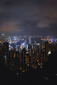 Illuminated cityscape against sky at night