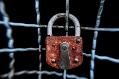 Close-up of padlock on metal fence