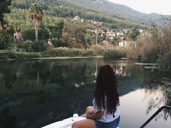 Rear view of woman looking at lake