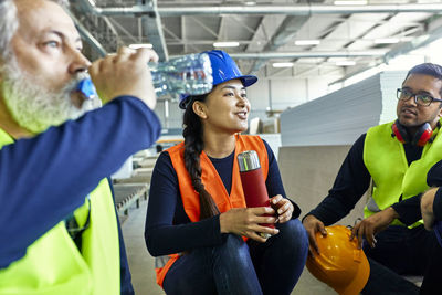 Workers in factory having lunch break together