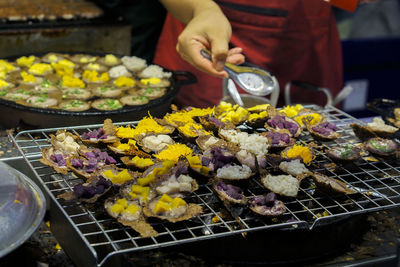 Man preparing food on barbecue grill