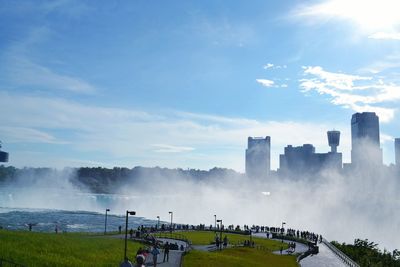 Panoramic view of buildings against cloudy sky