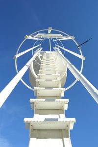 Low angle view of white ladder against sky